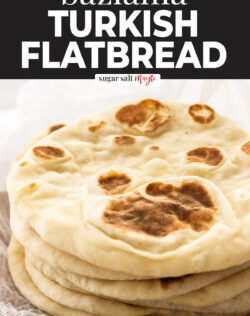 A stack of 7 flatbreads on a wooden board.