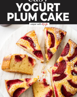 Slices of plum cake on a marble cake plate.