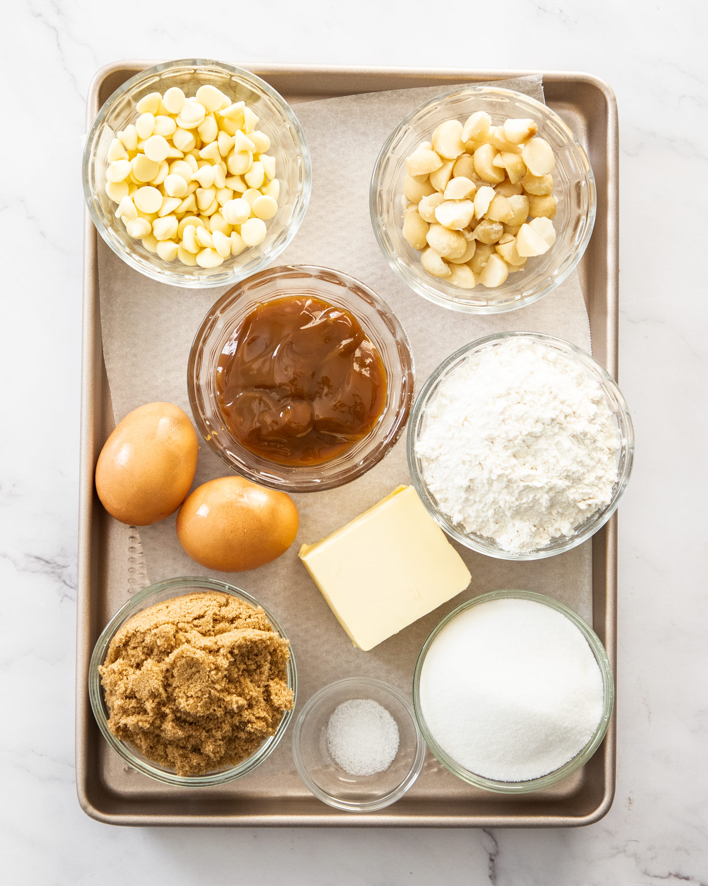 Ingredients for caramel blondies on a baking tray.