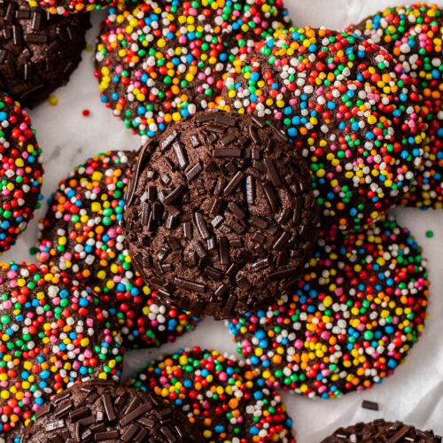 Close up of a chocolate sprinkle cookie with chocolate sprinkles on top.
