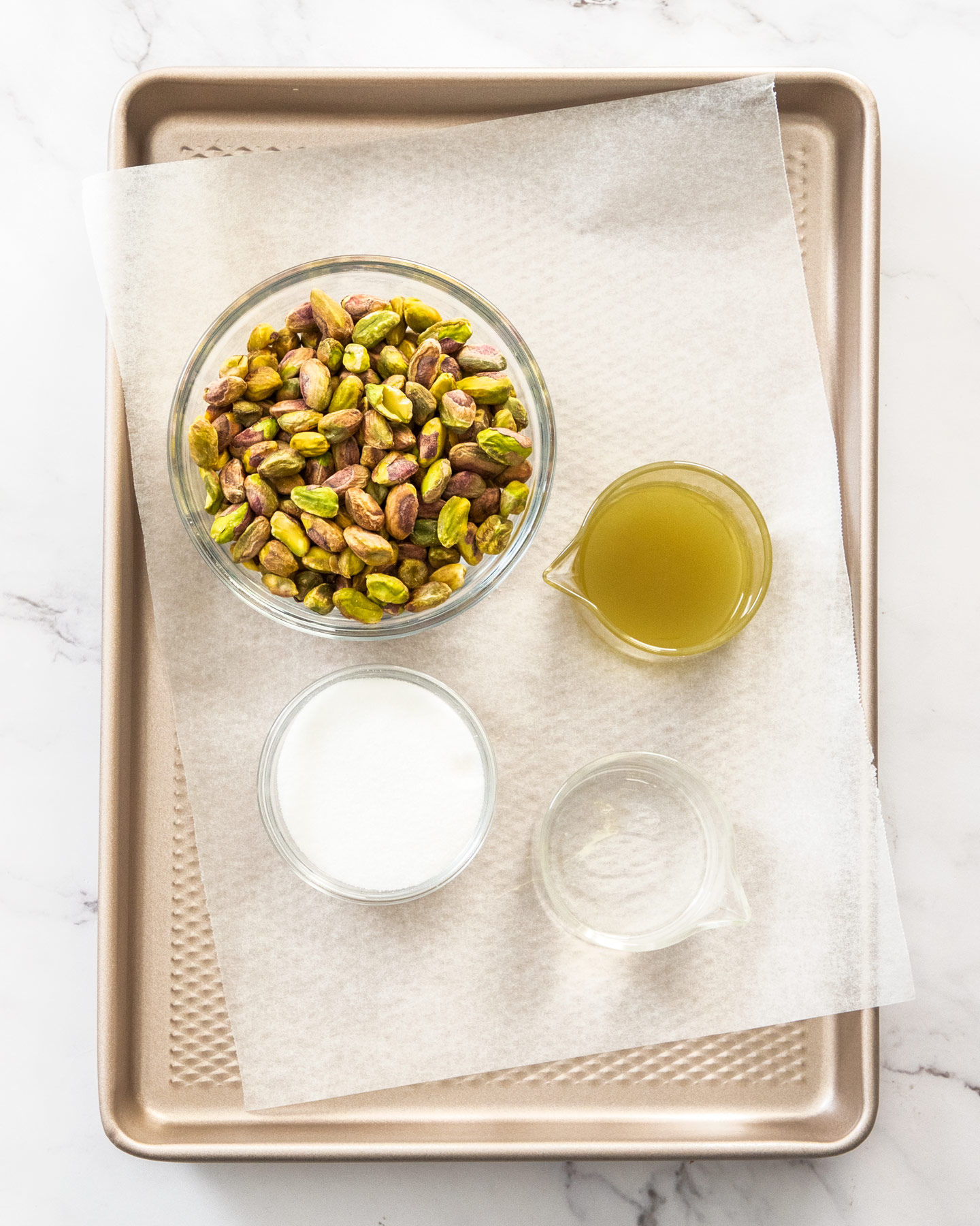 Ingredients for pistachio paste on a baking tray.