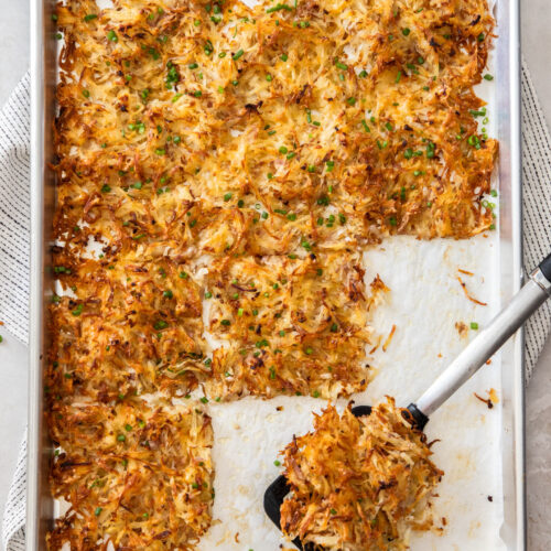 Top down view of baked hash browns on a baking tray.