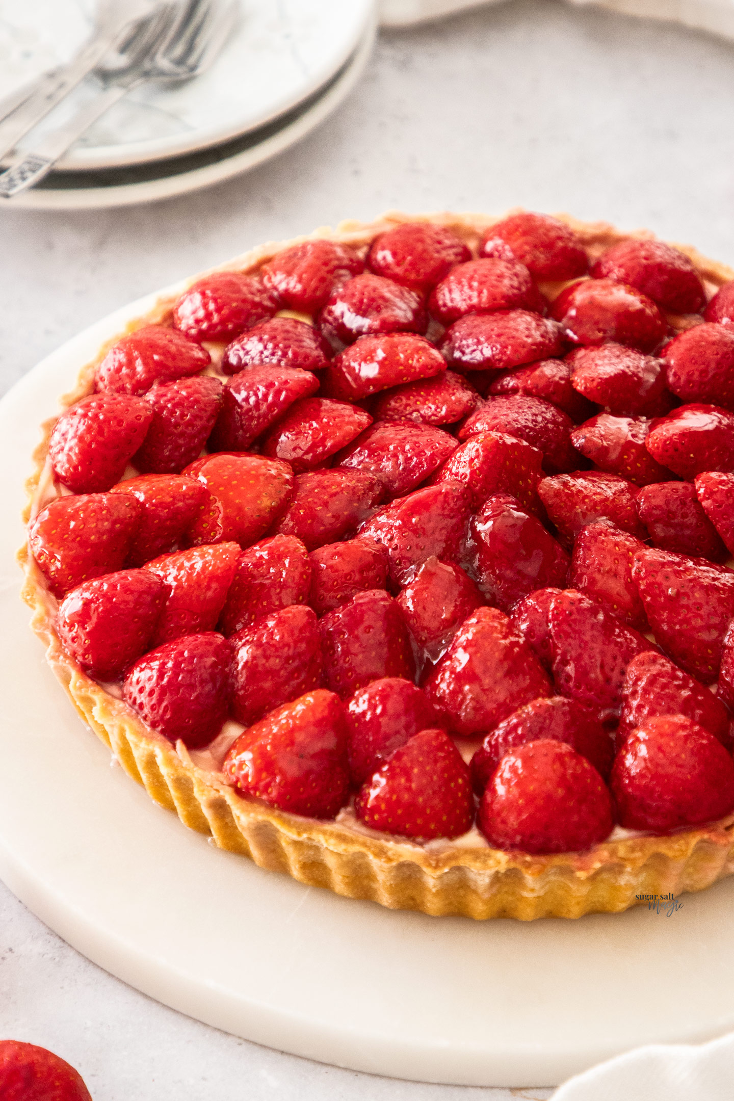 A tart topped with glazed strawberries.