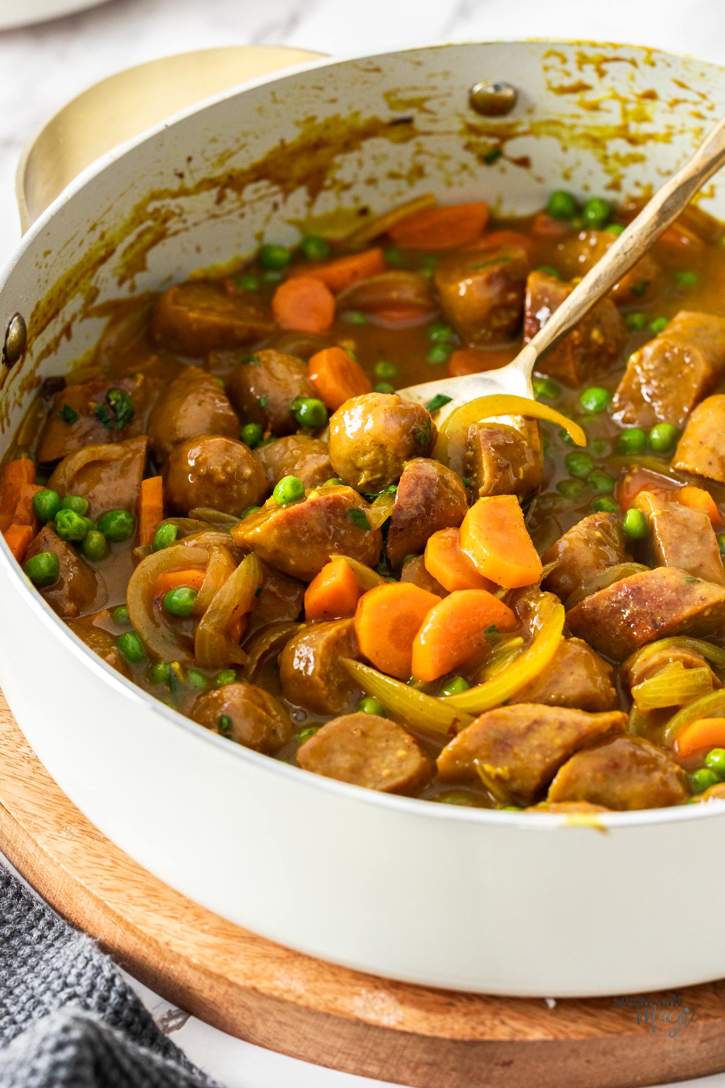 A pan filled with curried sausages.