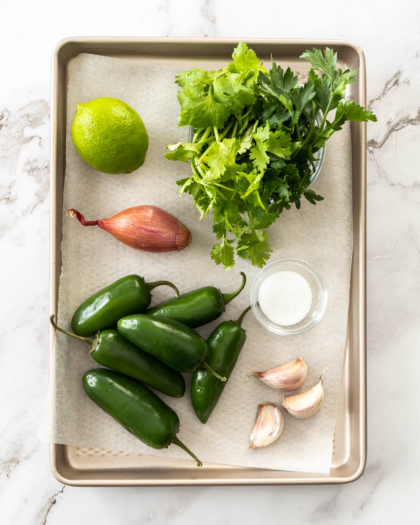 Ingredients for fresh jalapeno relish on a baking tray.