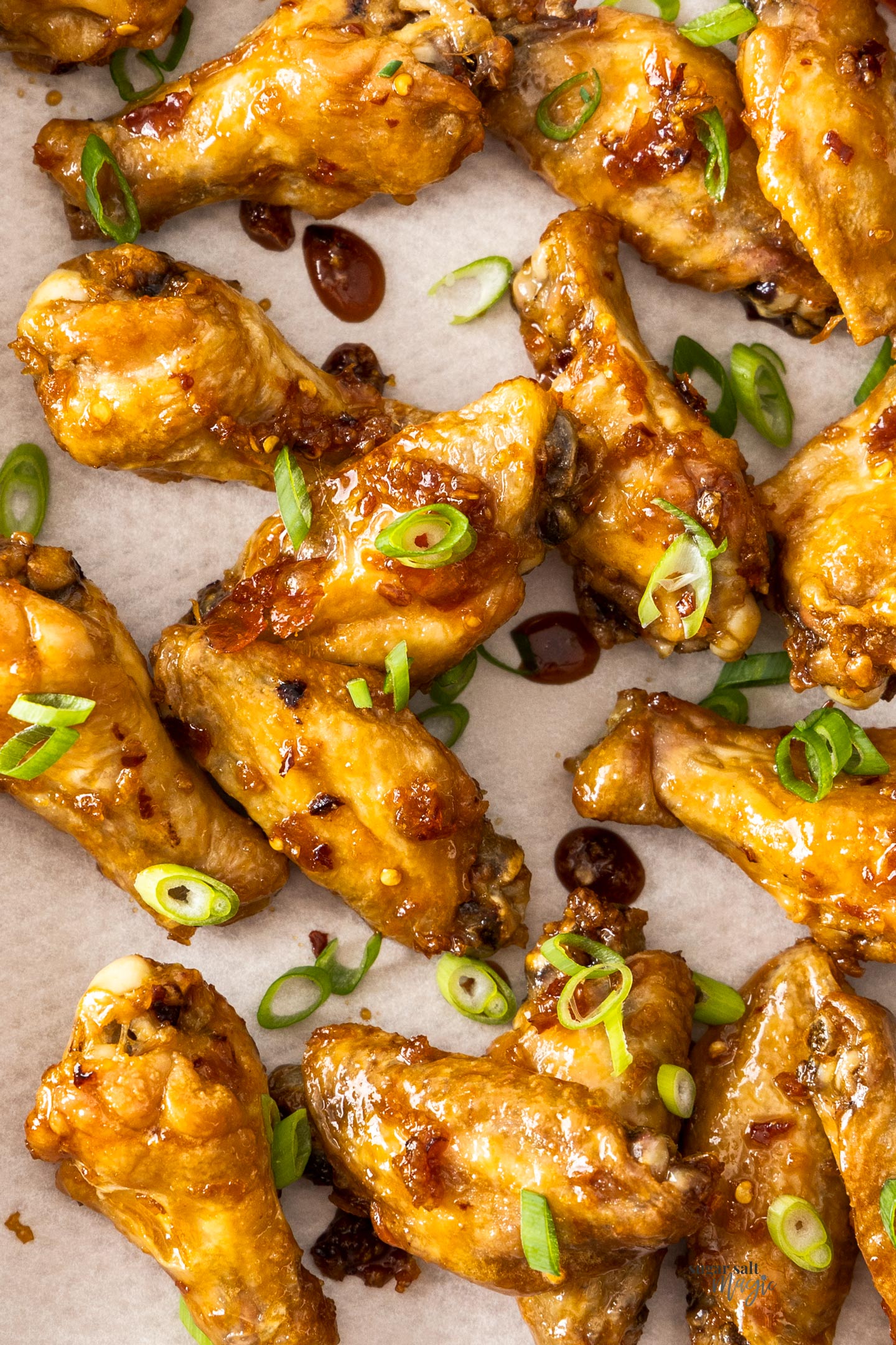 Top down view of a batch of chicken wings on a tray.
