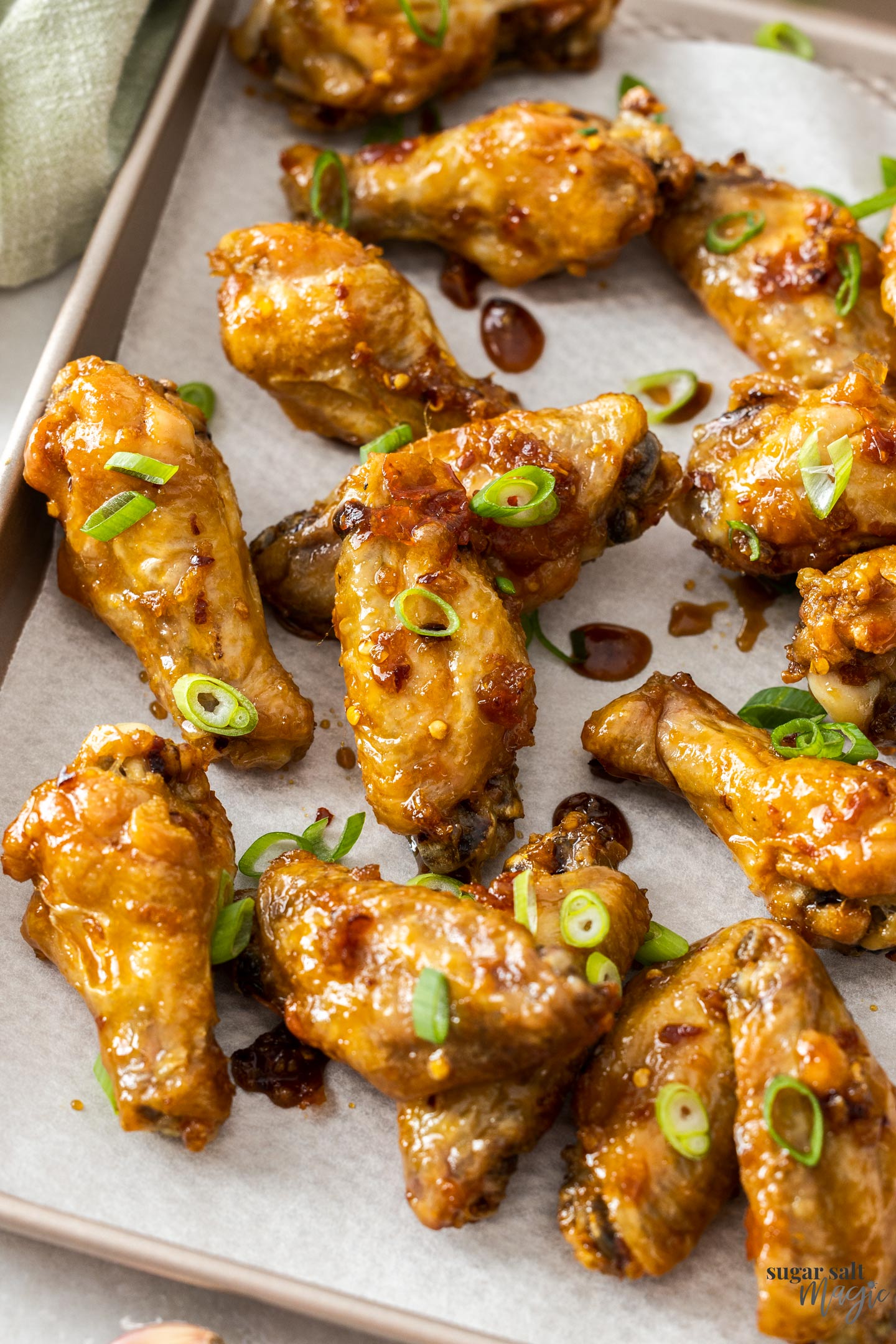 A batch of baked chicken wings on a baking tray.