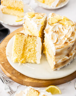 A lemon meringue cake cut into slices.