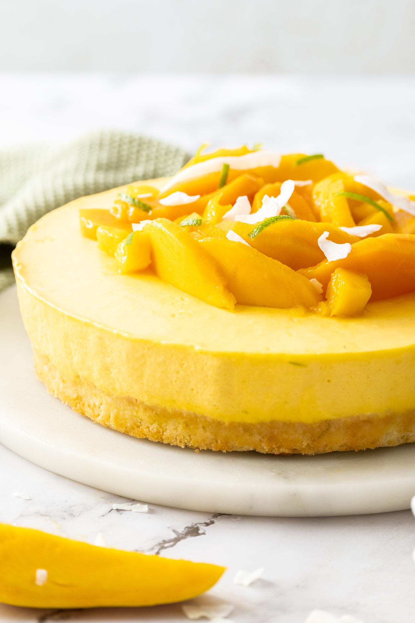 A mango mousse cake on a cake platter.