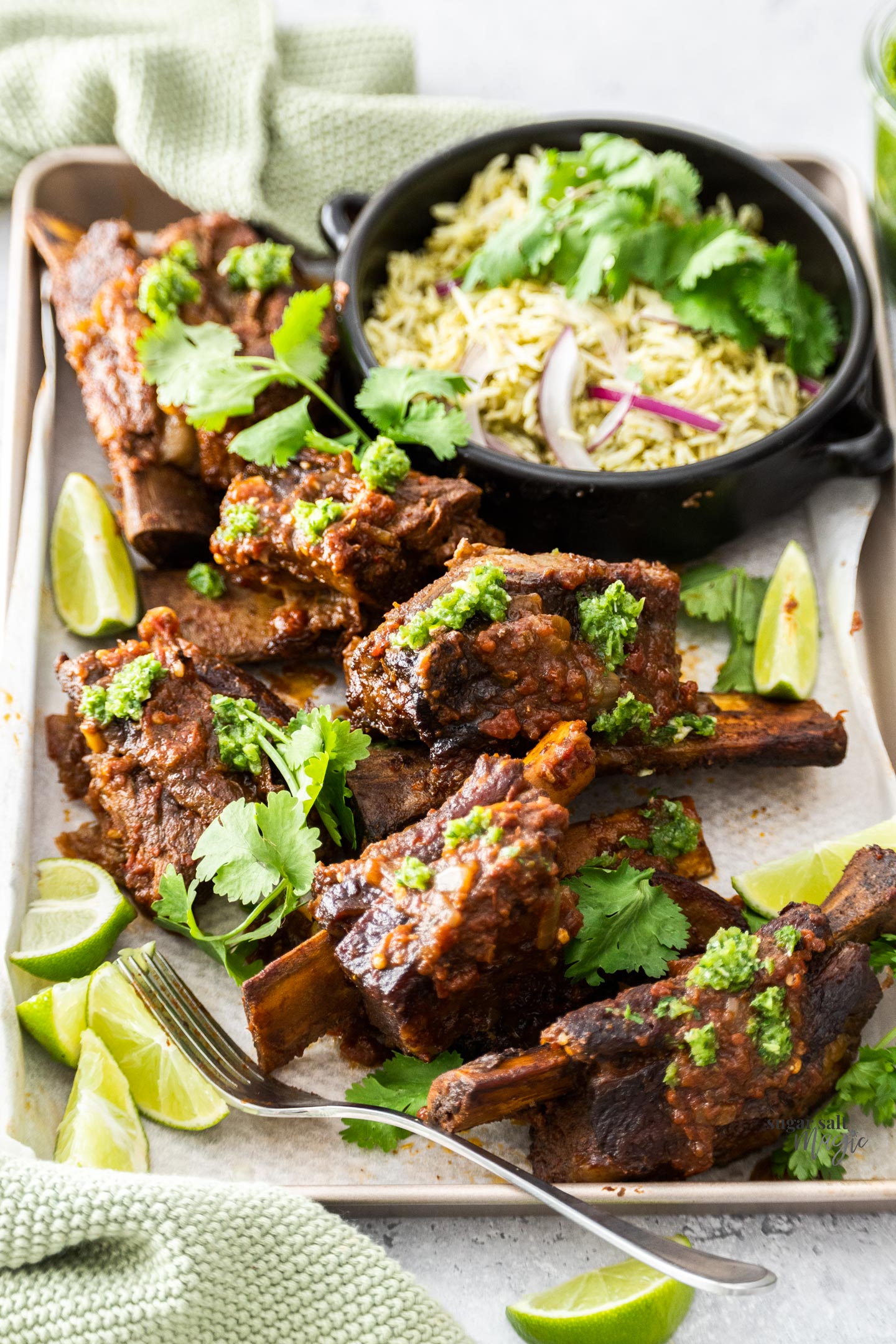 6 Mexican short ribs on a tray with rice.