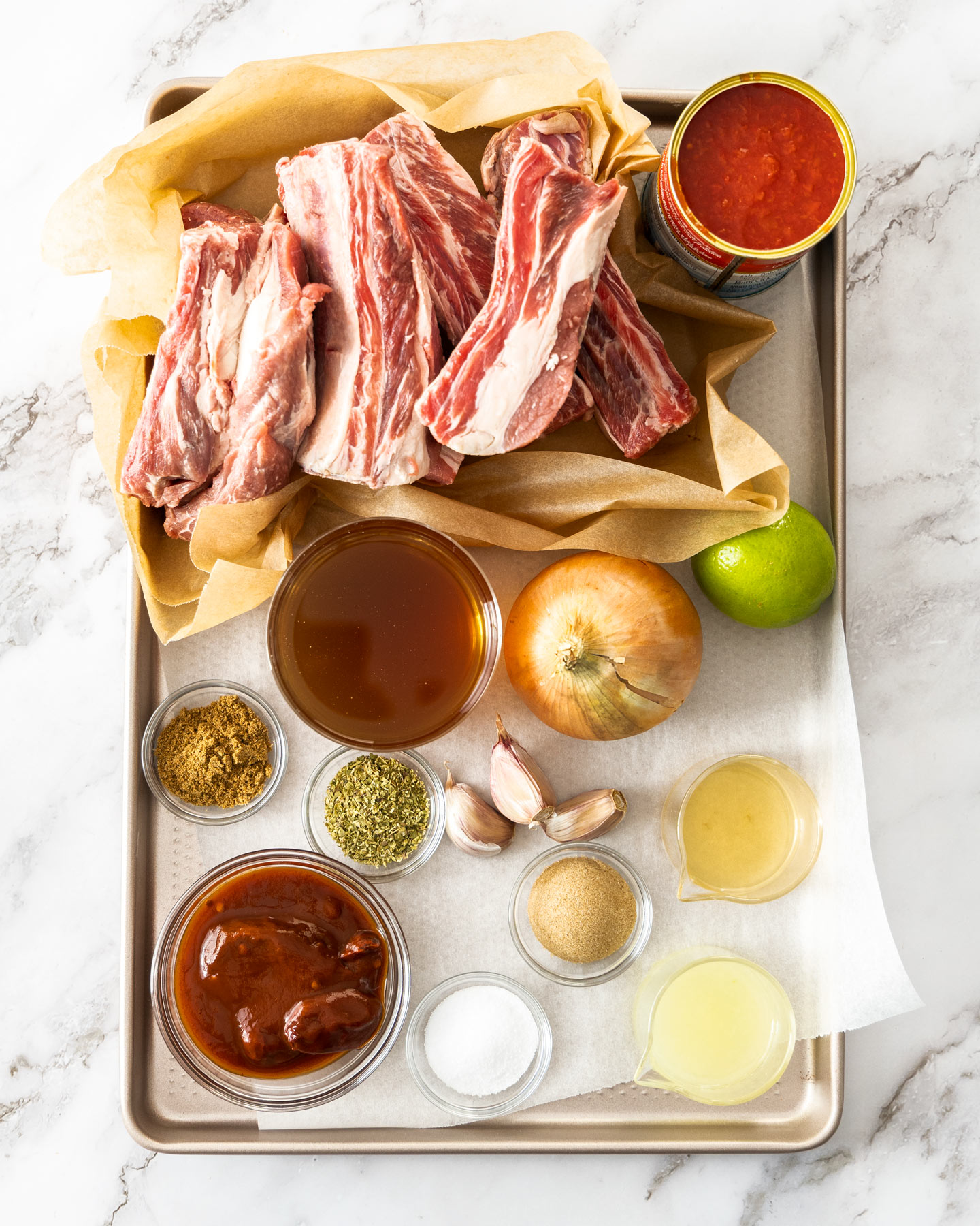 Ingredients for Mexican short ribs on a baking tray.