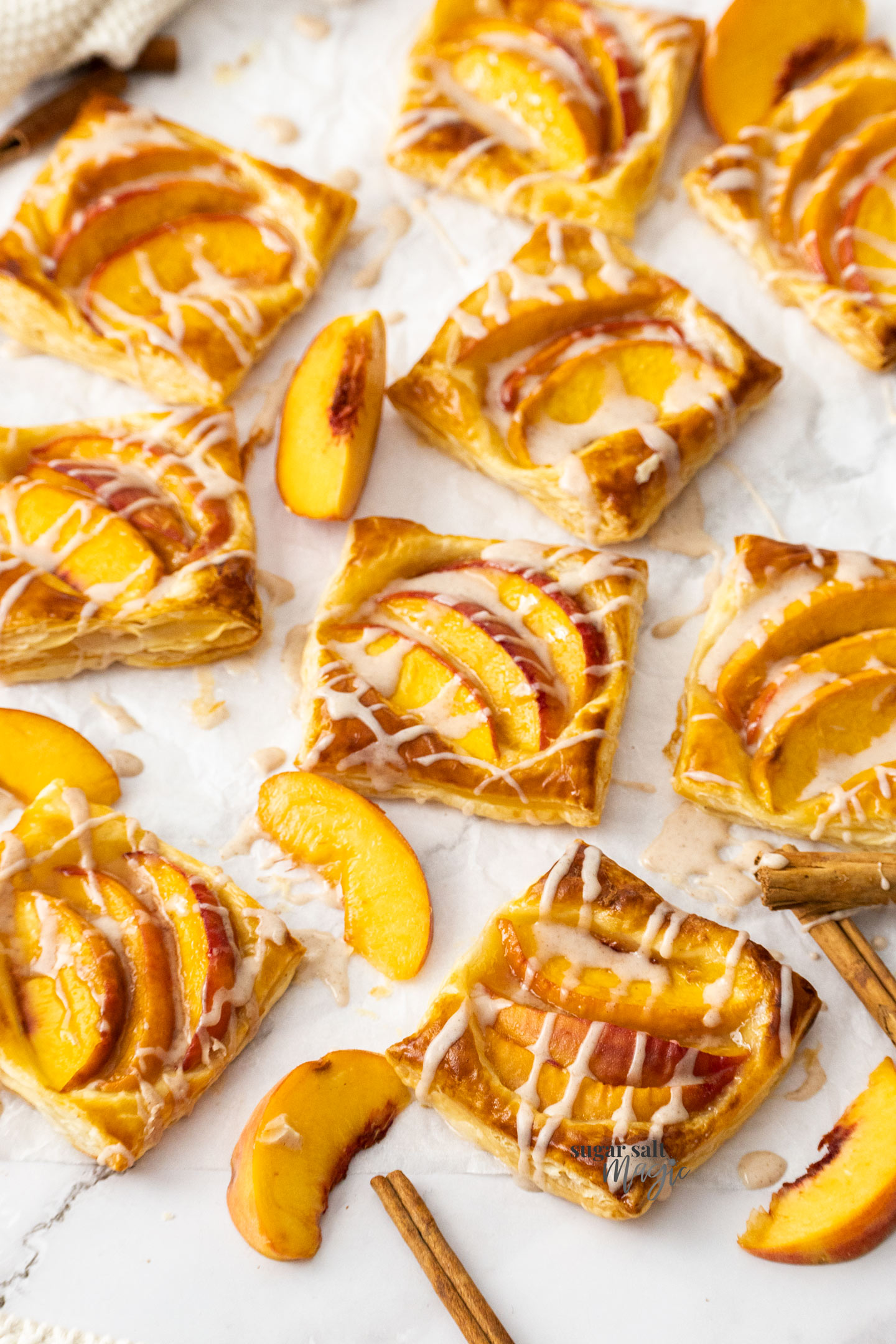 Mini peach tarts drizzled with icing.
