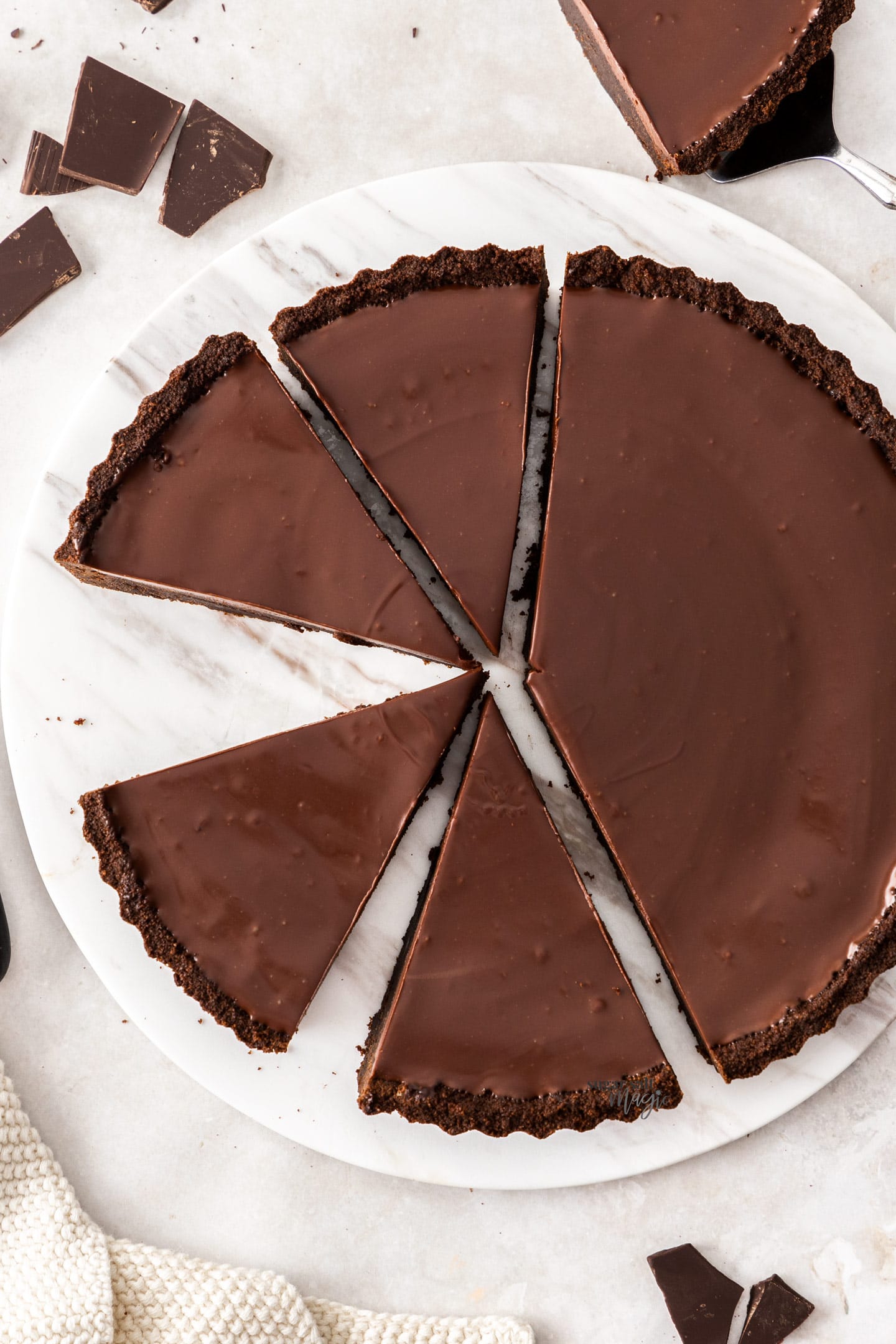 Top down view of a brownie tart cut into slices.