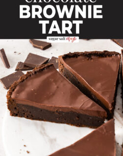 Slices of brownie tart on a marble platter.