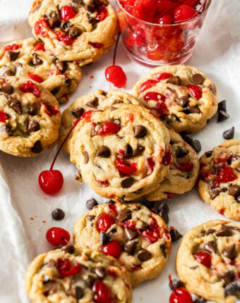 Closeup of the cookies with cherries dotted around them.