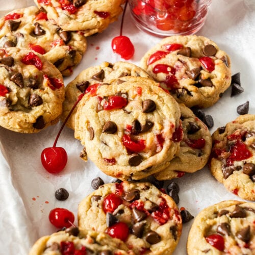 Closeup of the cookies with cherries dotted around them.