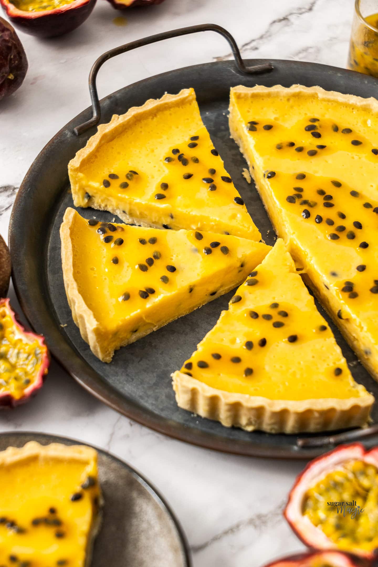 A passionfruit curd tart cut into slices.