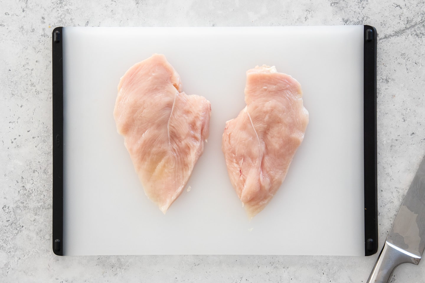 Two halves of a chicken breast fillet.