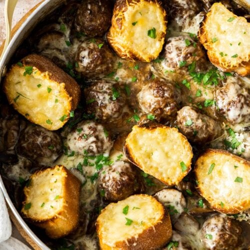 Meatballs and Gruyere croutons in a pan.