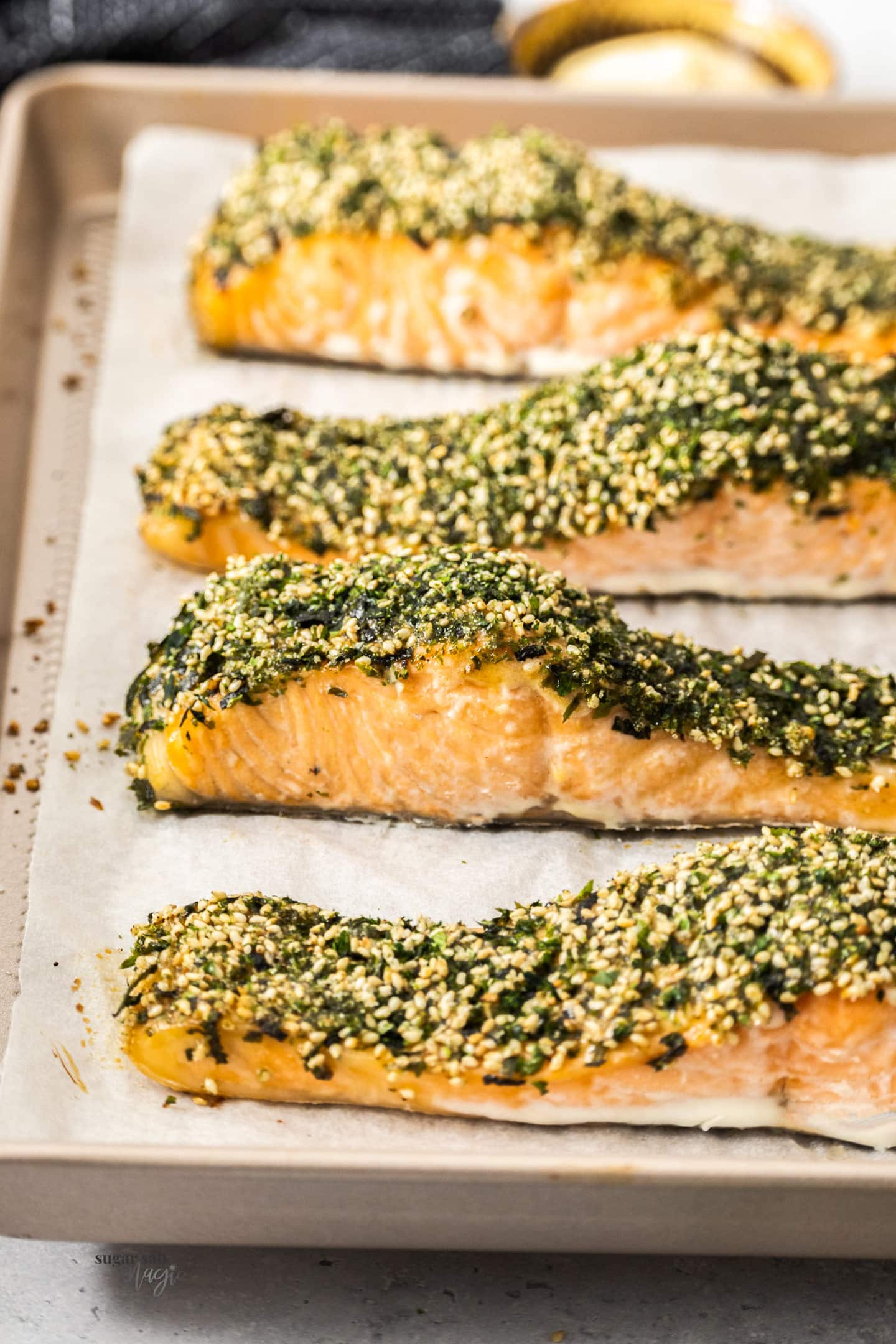 4 pieces of baked furikake salmon on a baking tray.