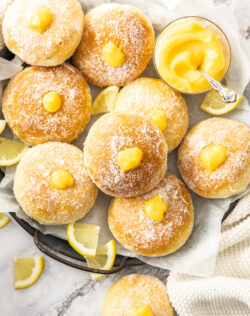Top down view of lemon donuts on a metal tray.