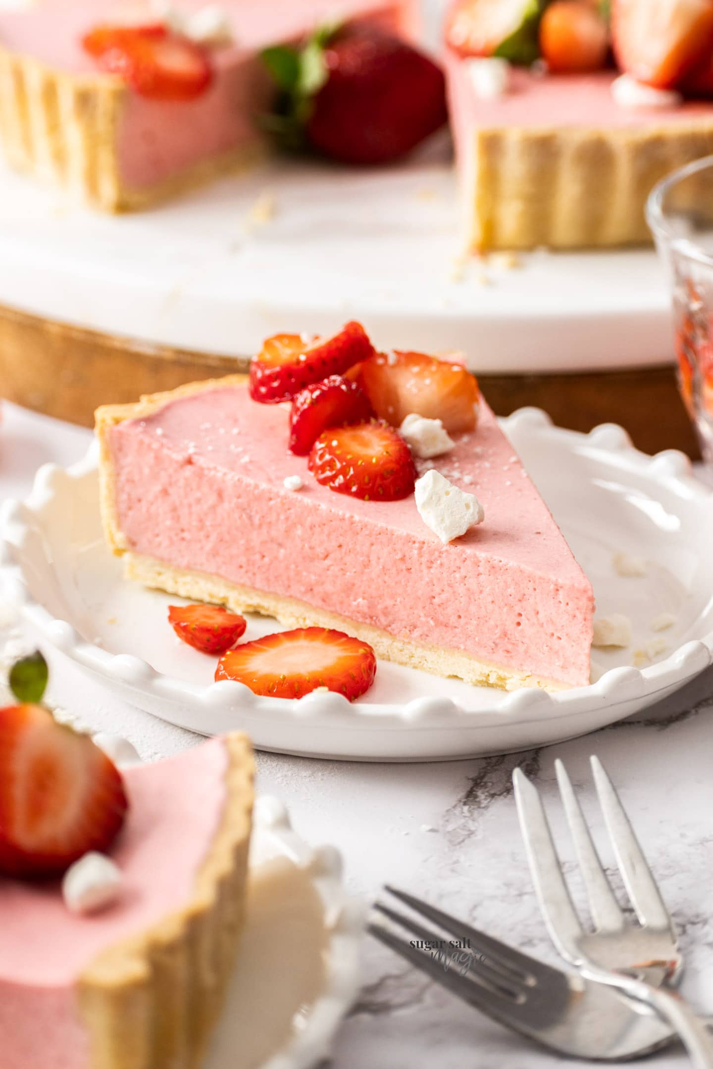 A slice of strawberry mousse tart on a small dessert plate.