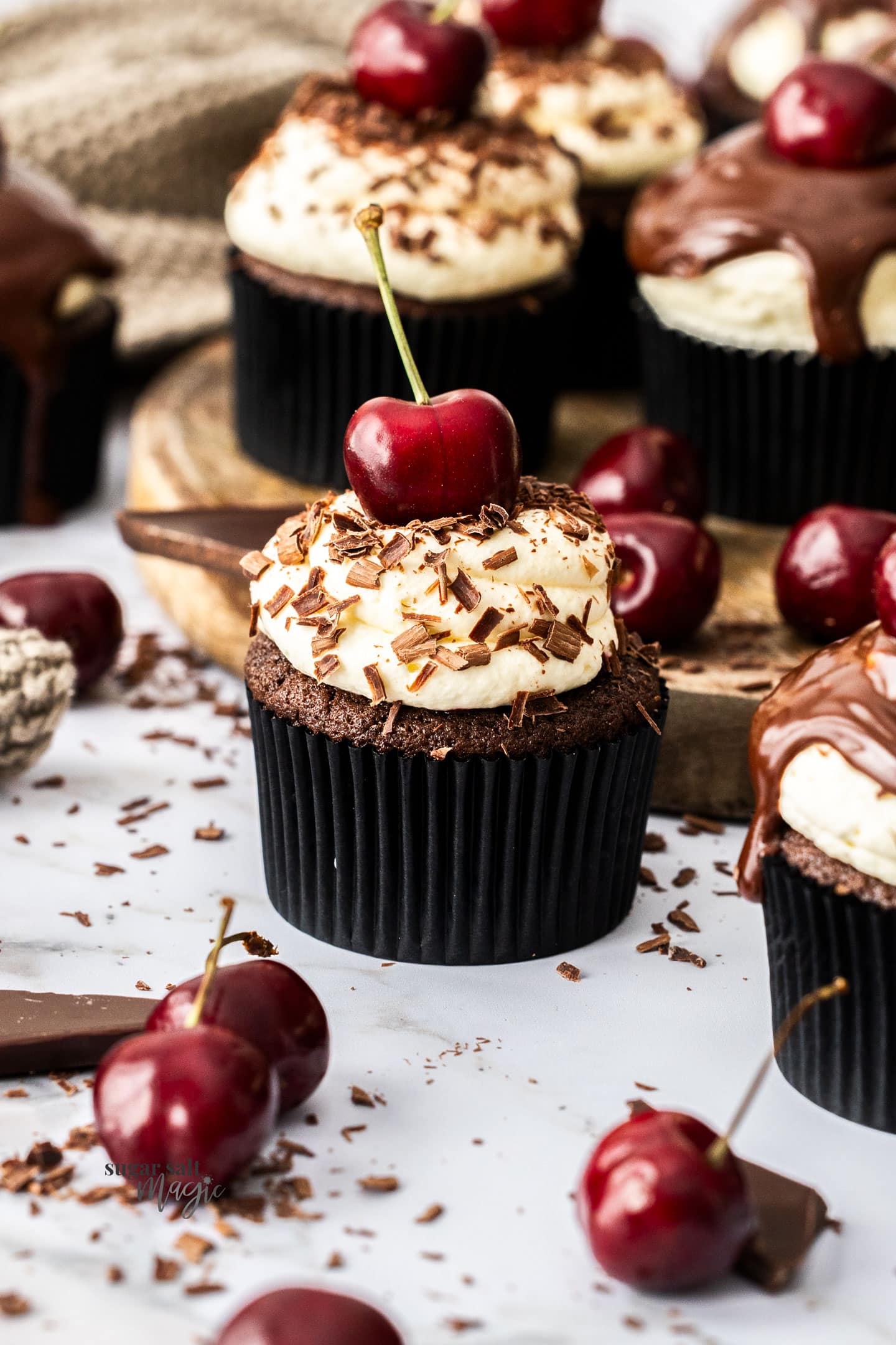 A single black forest cupcake with chocolate shavings.