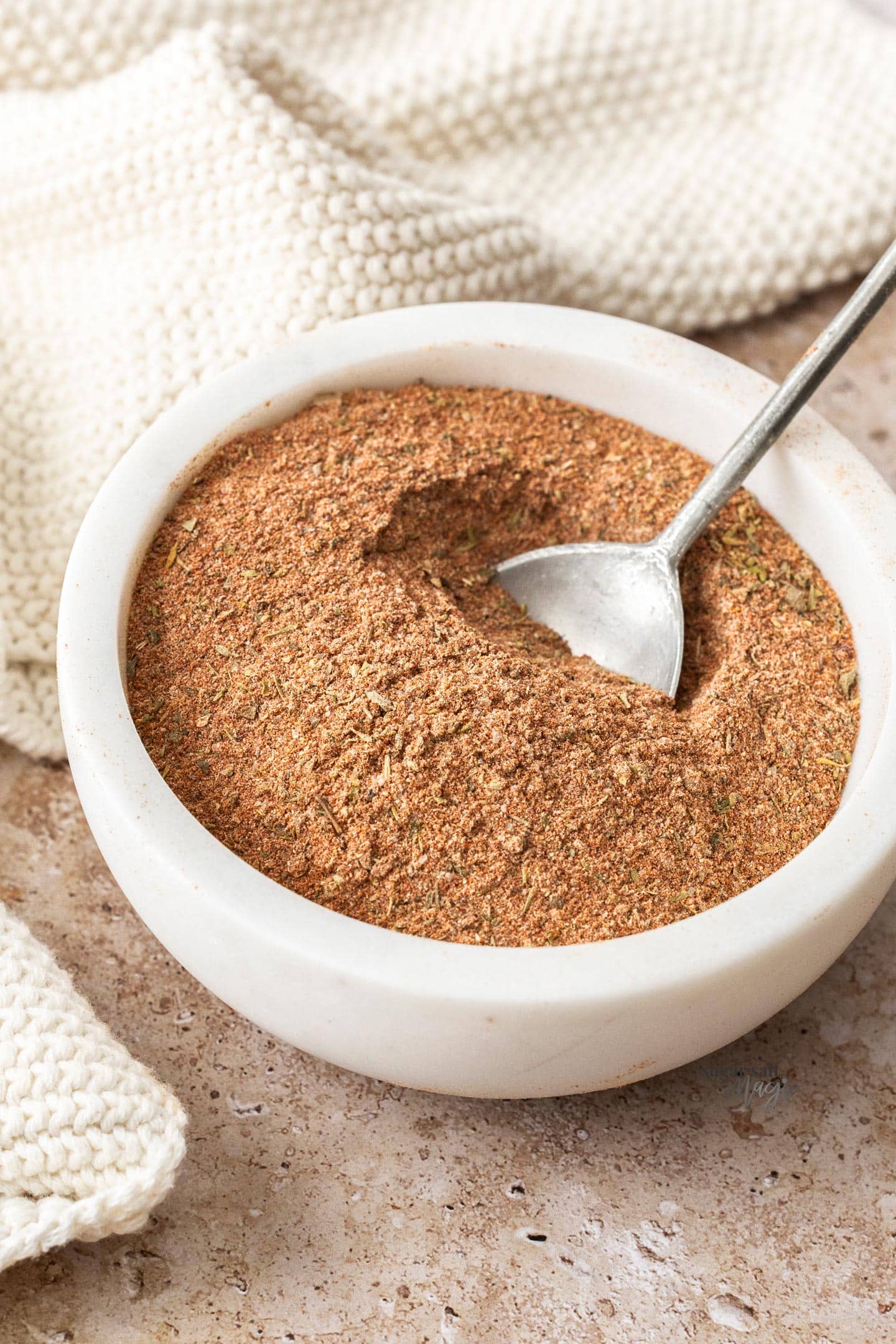 Cajun seasoning in a bowl with a spoon.