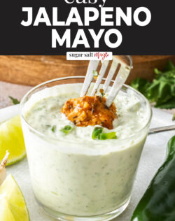 A piece of chicken being dipped into jalapeno mayo.