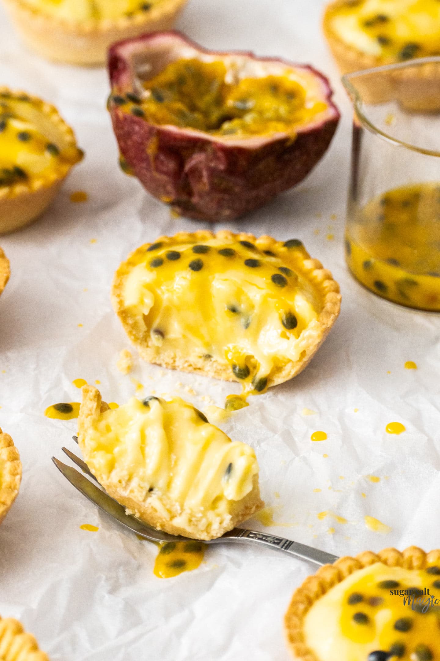 A passionfruit tartlet with part of it cut away showing the texture.