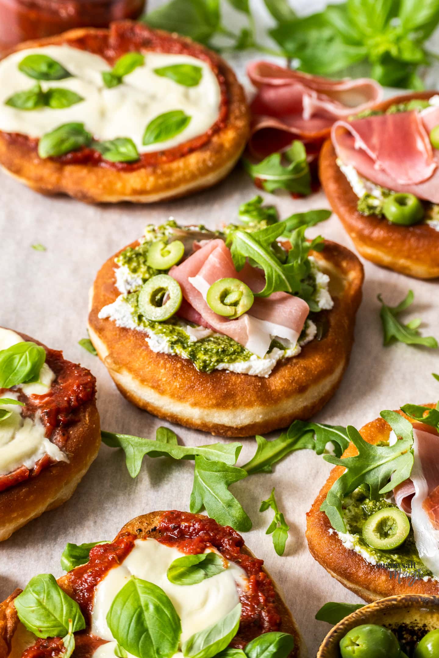 A fried pizza topped with pesto and prosciutto.