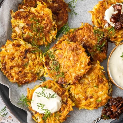 Golden, crispy potato fritters on a serving tray.
