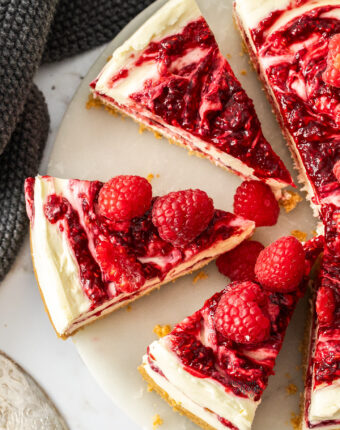 Top down view of 3 slices of raspberry cheesecake.