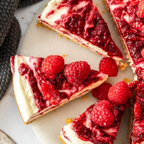 Top down view of 3 slices of raspberry cheesecake.