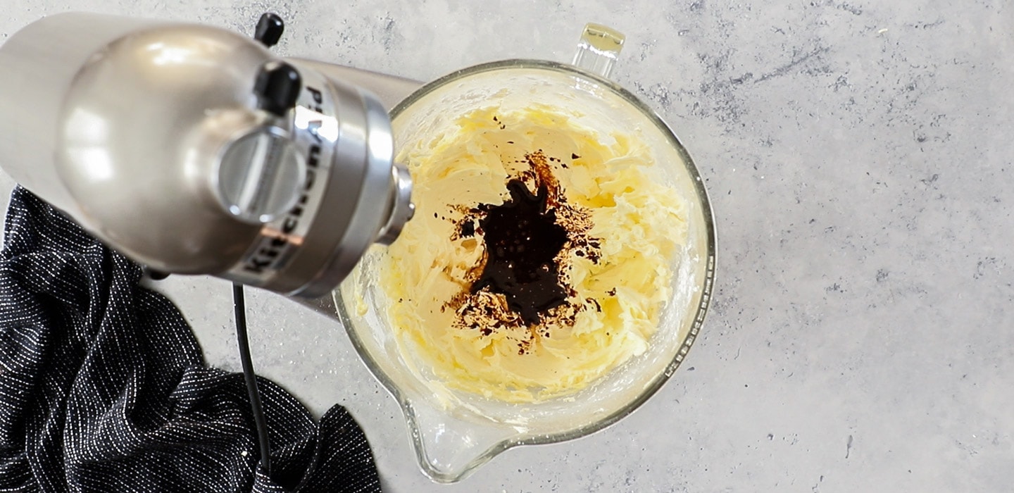 A stand mixer with whipped butter and coffee added.