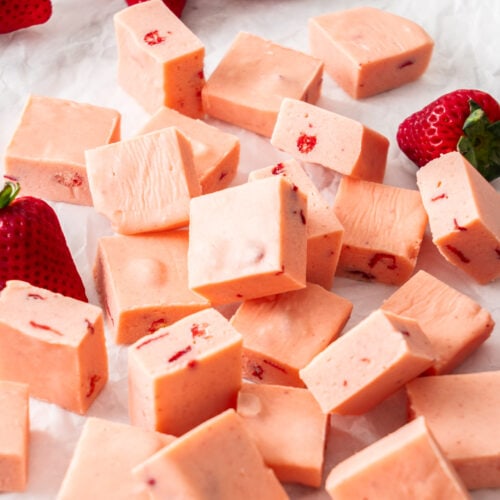 A pile of squares of strawberry fudge.