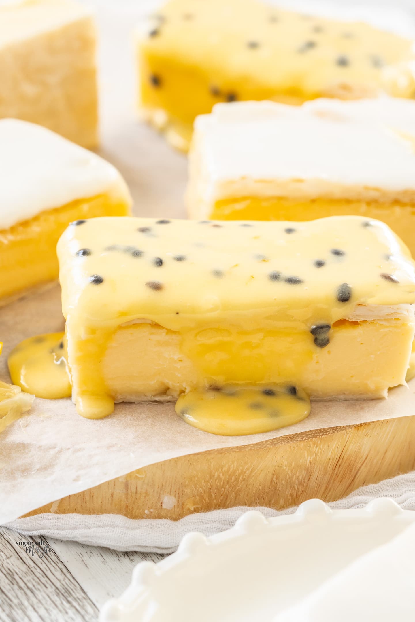 Closeup of a vanilla custard sliced topped with passionfruit icing.