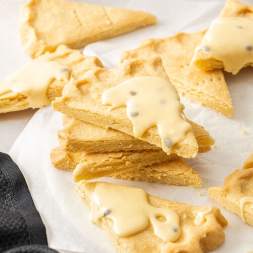 A stack of butter shortbread with passionfruit icing on the top one.