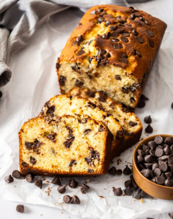 Slices of chocolate chip loaf cake leaning up against each other.
