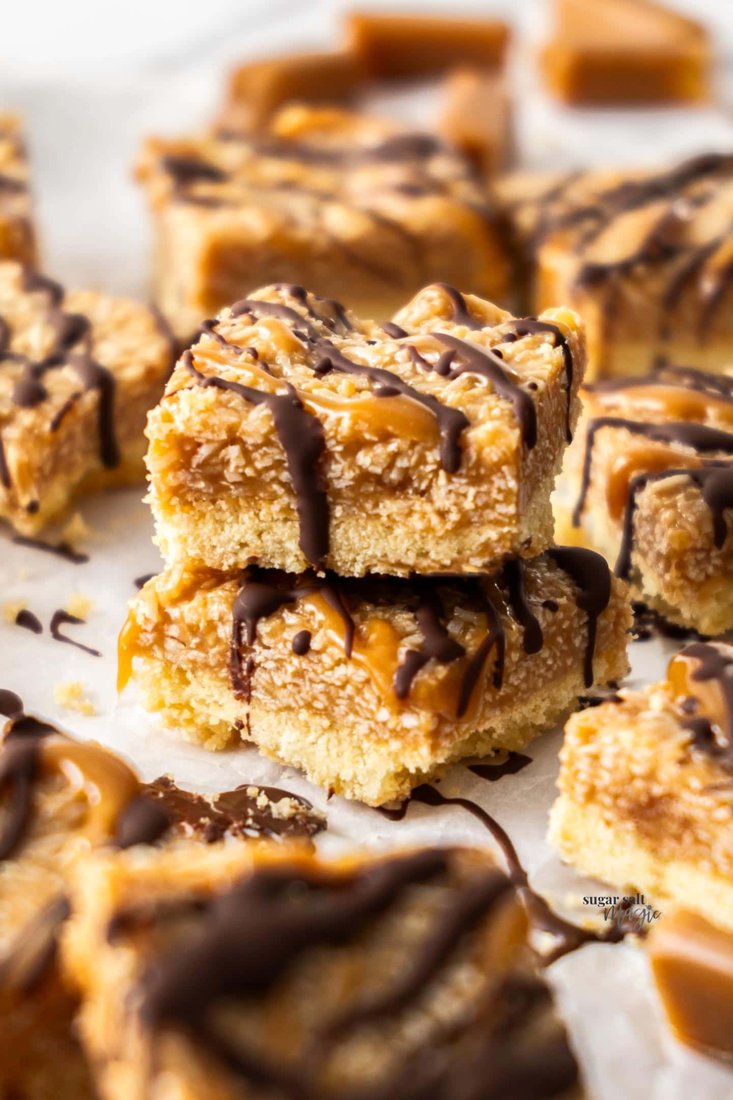 Two coconut caramel bars stacked.