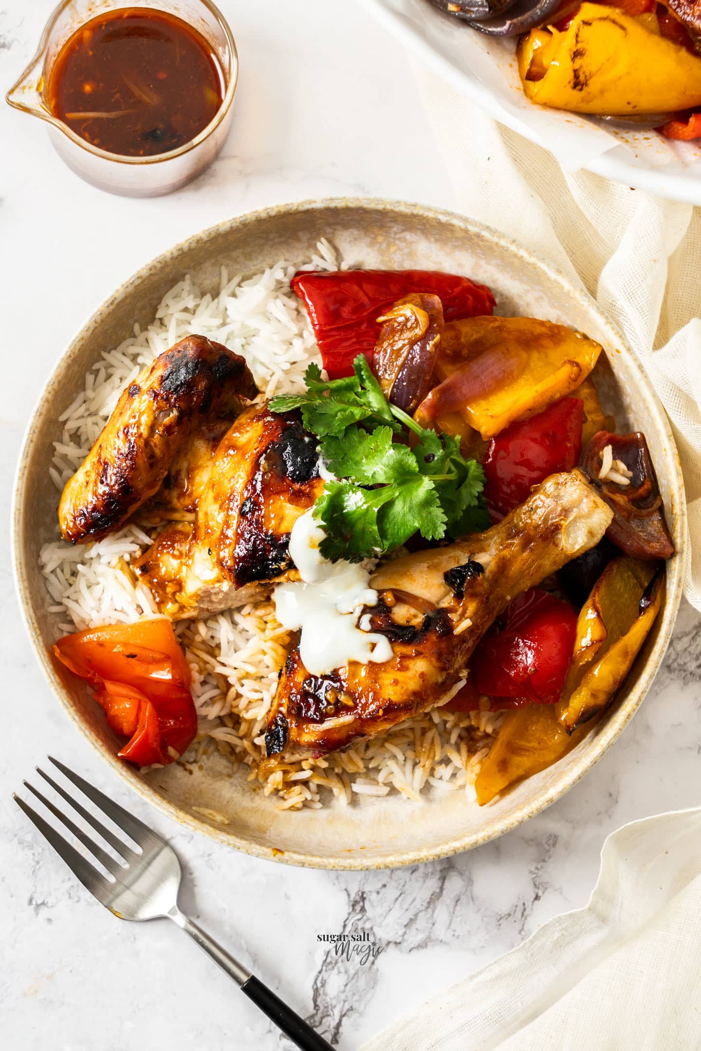 Harissa chicken with rice and yoghurt in a dish.