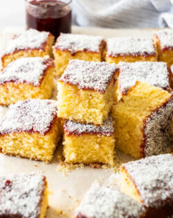 Some squares of cake stacked, surrounded by more.