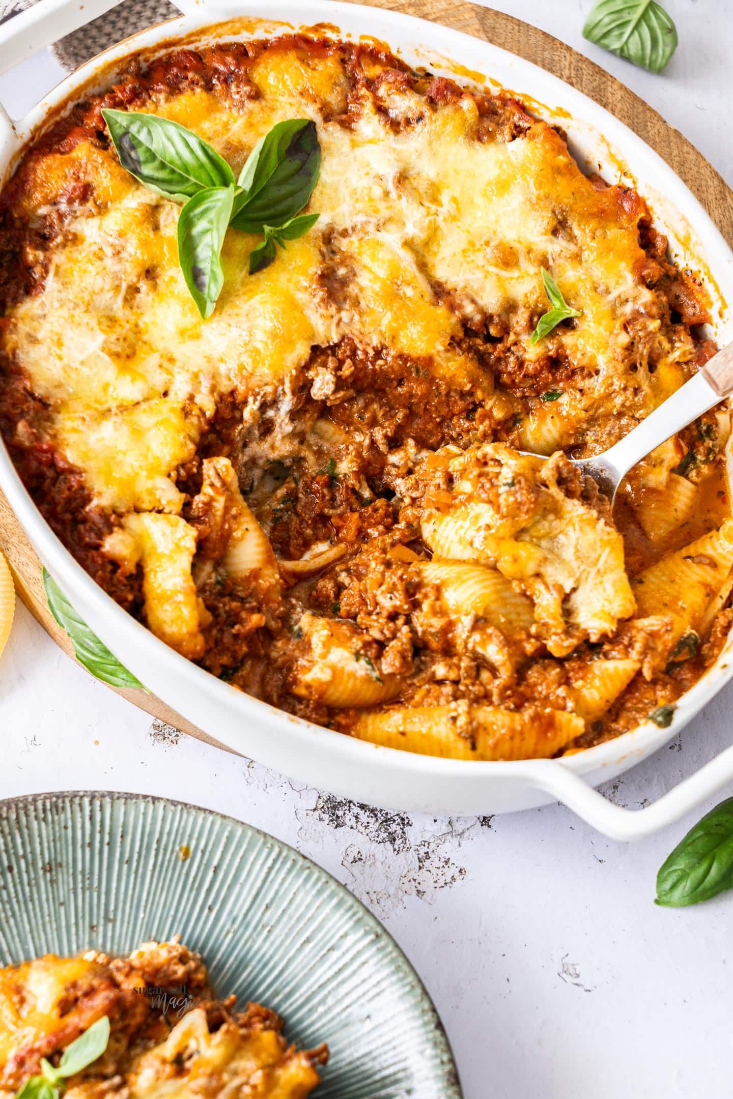 A baking dish filled with baked lasagna stuffed shells.