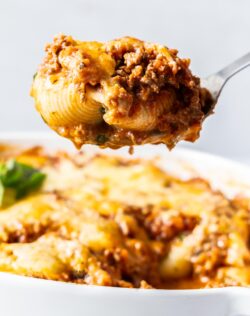 Baked lasagna shells on a scoop.