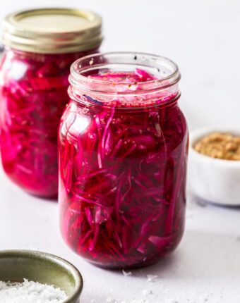 Closeup of a mason jar filled with pickled red cabbage.