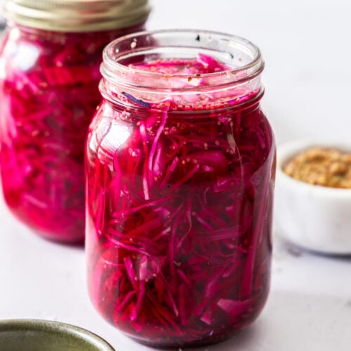 Closeup of a mason jar filled with pickled red cabbage.