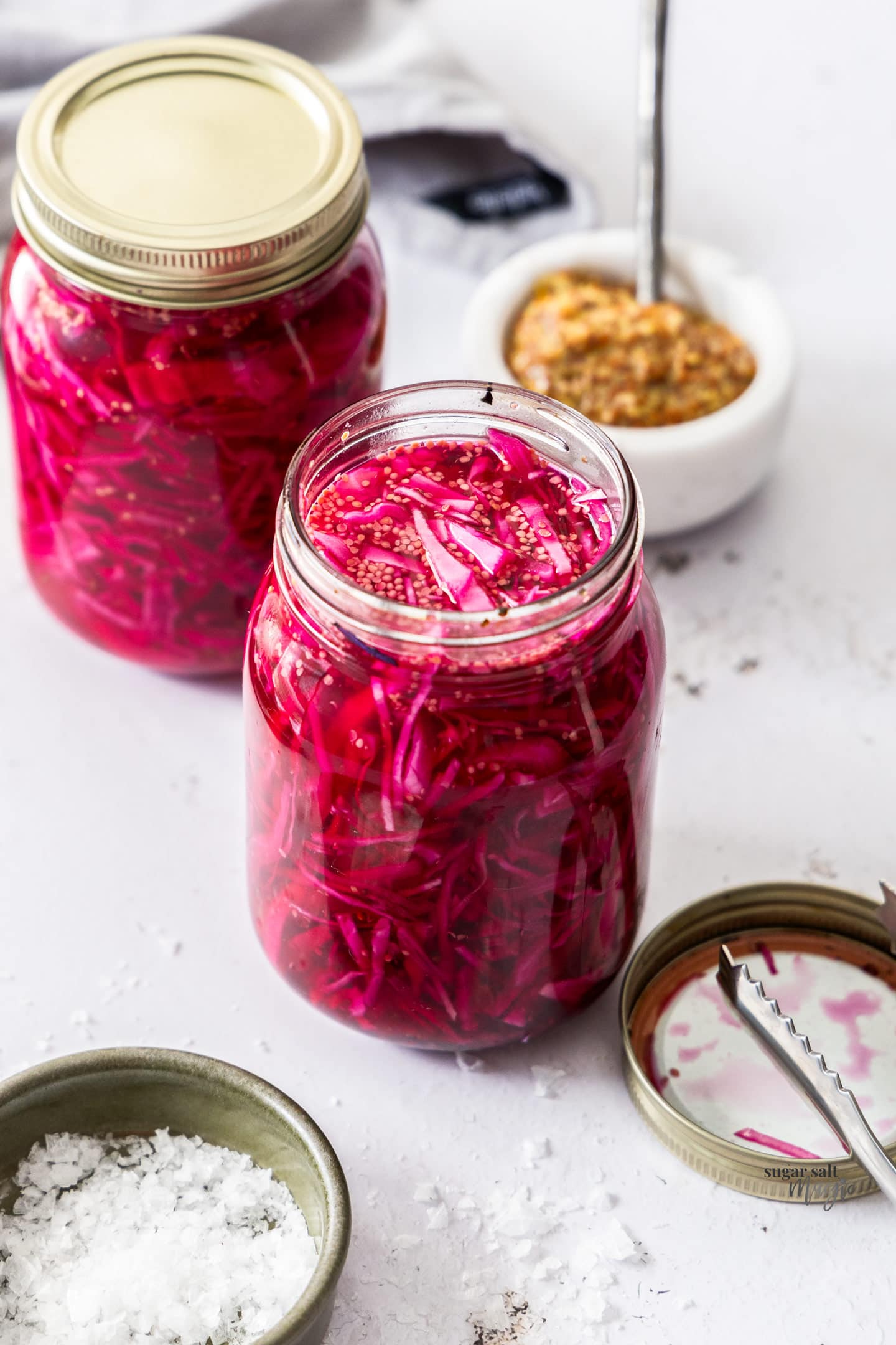Looking down at pickled red cabbage in a jar.