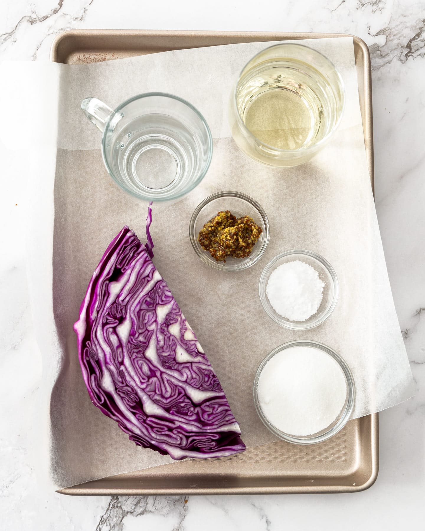 Ingredients for pickled red cabbage on a baking tray.