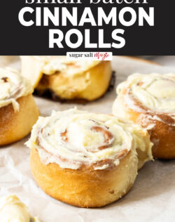 4 cinnamon rolls topped with cream cheese frosting.
