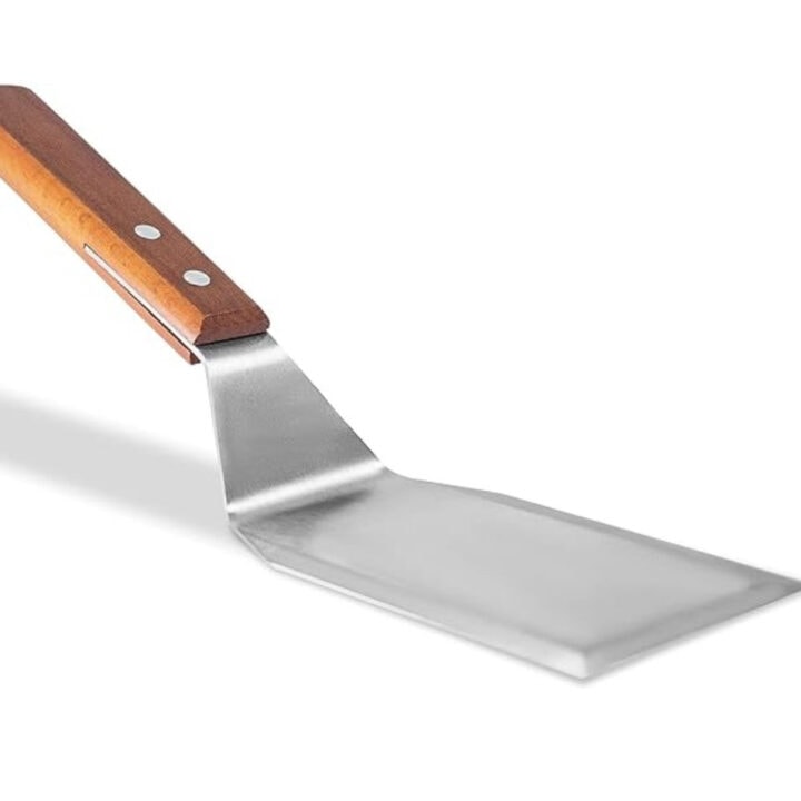 A metal offset spatula with a wooden handle.